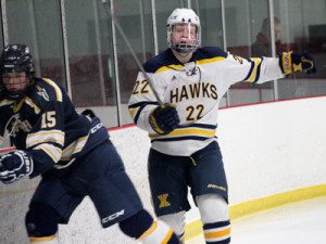 Xaverian’s Ryan Pompeselli (22) collides with Needham’s Tim Hasenfus (15) behind the Rocket net late in the second period.
