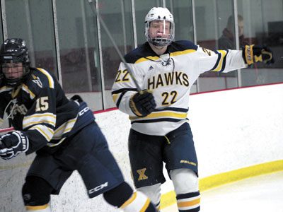 Xaverian’s Ryan Pompeselli (22) collides with Needham’s Tim Hasenfus (15) behind the Rocket net late in the second period.
