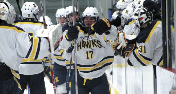 Xaverian freshman forward Robbie Barletta (17) celebrates with teammates at the bench following his game-tying goal with 1:26 to play against Needham on Wednesday night.