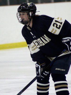 Needham senior captain and defenseman Rose Evans (21) awaits a pass from the corner. Photos by Michael Flanagan