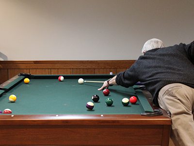 The monthly K.I.S.S. pool tournament attracts local senior pool hustlers to the Tolles Parsons Center to play.  Photos by Laura Drinan