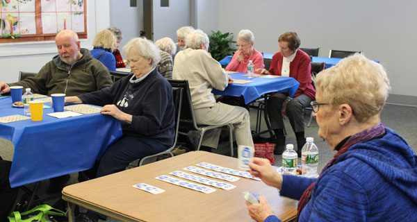 Sue Sheridan calls the letter and number combination at the Dover COA’s annual bingo luncheon. Photos by Laura Drinan