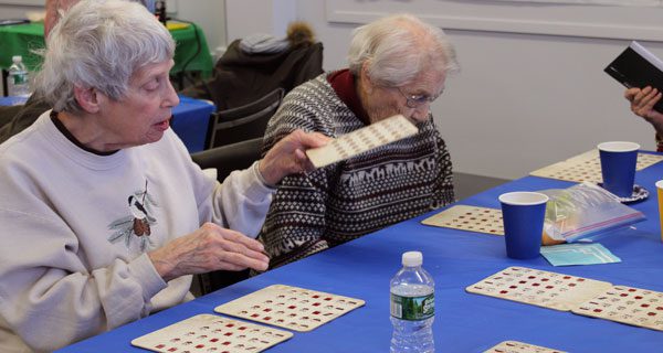 The bingo players at the COA’s January luncheon mark their cards in hopes of winning a prize. Photos by Laura Drinan