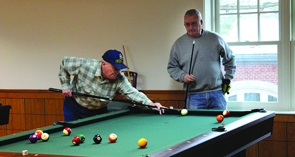 Local seniors at the Tolles Parsons Center compete in the monthly K.I.S.S. pool tournament. Photos by Laura Drinan