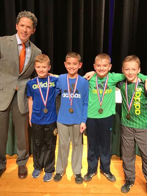 Moderator Sean Bevan, principal of Westwood High School, with ‘ADIDAS – All Day I Dream About Spelling,’ the winning team of the fourth grade spelling bee.