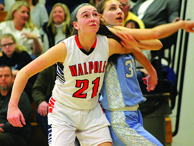 Walpole center Jill White (21) boxes out Medfield’s Arianna Tristani (30) for a second quarter rebound. Photos by Michael Flanagan