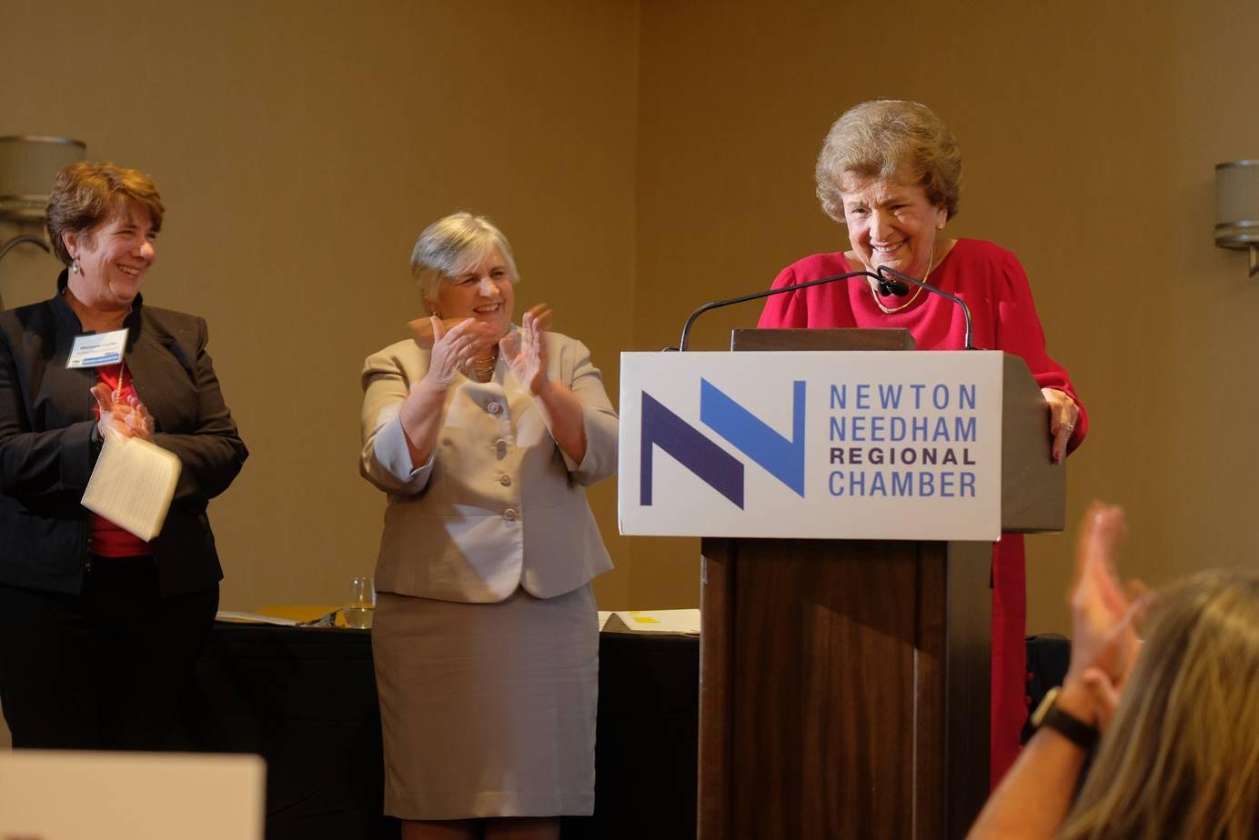 Louise Condon accepts the Newton-Needham Regional Chamber’s honor for decades of unparalleled service to the town at the First Annual Needham Night dinner Jan. 31 at the Sheraton. The award was presented by, from left, Needham Select Chair Marianne Cooley and State Rep. Denise Garlick. Photos by Bob Keene