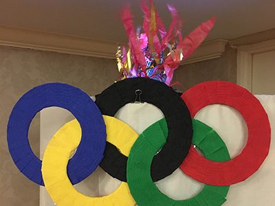 Residents at New Pond Village kick-off their Winter Olympics with an opening ceremony and mock torch lighting.