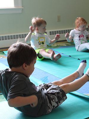 Led by Erin Mann, the Medfield Library’s yoga class challenges children to think about their muscles and breathing. Photos by Laura Drinan