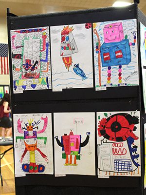 Dale Street students display their robot drawings based off of Peter Brown’s ‘Wild Robot’ at the school’s art show. Photos by Laura Drinan
