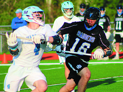 DS’s Ben Weitzman (18) defends against Medfield’s Tom Schofield (4) on a rush up the field early in the first quarter. Photos by Michael Flanagan