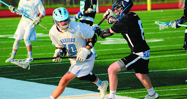 Medfield’s Mike Tyer (40) attempts to fight through a check from DS’s John Sveen (8) midway through the first quarter. Photos by Michael Flanagan