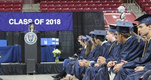 Makenna Woodward-Crackower addresses her fellow classmates as Needham High’s class of 2018 prepares to turn their tassels. Photos by Laura Drinan