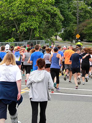 Runners during the start of the 5K head down South Street. Photos by Daniel Curtin