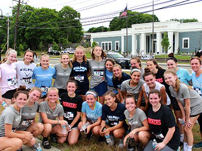 Members of the field hockey and lacrosse teams at Walpole High who participated in the 5K take a group picture after the run. Photos by Daniel Curtin