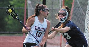 eedham junior captain Chloe Newman (23) defends against Wellesley’s Maddy Balter (10) on a drive to the cage early in the first half. Photos by Michael Flanagan