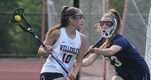 Needham junior captain Chloe Newman (23) defends against Wellesley’s Maddy Balter (10) on a drive to the cage early in the first half. Photos by Michael Flanagan