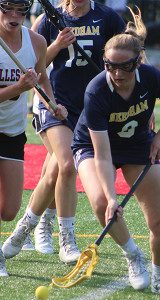 Eileen Manning (9) scoops through a groundball off of a Needham faceoff victory. Photos by Michael Flanagan