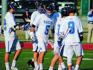 Michael Mastrobuono (5), Pierce Gregory (3) and teammates celebrate a goal early in the third quarter. Photos by Michael Flanagan