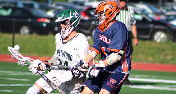 Kyle Hirshom (11) forces a turnover on Westwood’s Charlie Harrington (24) early in the third quarter. Photos by Michael Flanagan