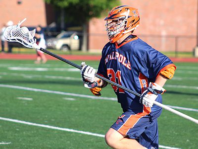 Senior defensive pole Pat Lanahan (31) moves the ball up the field for Walpole midway through the third quarter. Photos by Michael Flanagan