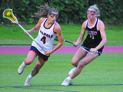 Wellesley’s Phoebe Lawrence (12) defends against Walpole’s Audra Tosone (4) midway through the first half. Photos by Michael Flanagan