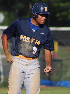 Alex Cherry (9) dusts himself off after stealing second in the bottom of the second inning before coming around to score. Photos by Michael Flanagan