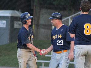 James Donovan (left) is congratulated by coach Chris Krechting (23) after his walk-off RBI suicide squeeze in the bottom of the seventh inning. Photos by Michael Flanagan