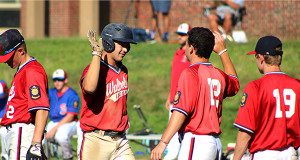 Charlie Auditore is congratulated by Teammates Chris McLean (12) and Ryan Boyajian (19) after coming around to score in the bottom of the first. Photos by Michael Flanagan