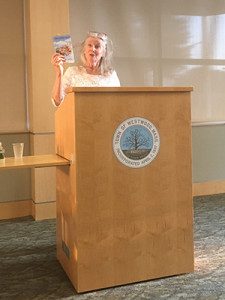 Berg shows off “Make Someone Happy” before beginning her reading. Photos by Emily Greffenius