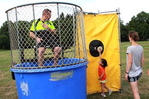 One of Walpole’s finest about to be dunked by an Ice Cream Festival reveler. Photos by Daniel Curtin