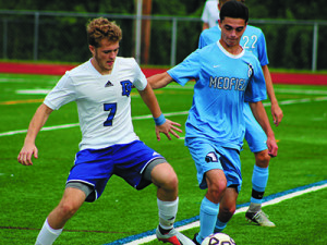 Medfield’s Joseph Layden (8) and DS’s Hans-Martin Heer (7) battle for a loose ball late in the first half.