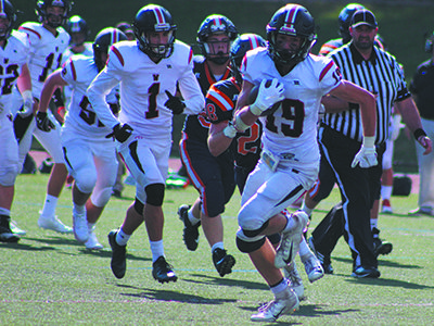 Wellesley wide-out Teddy Komjathy (19) cuts up the field before dashing 46 yards to the end zone to tie the game on Saturday at Walpole.