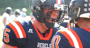 Walpole senior offensive guard Patrick Colburn (75) congratulates Will Jarvis after his second quarter touchdown run.