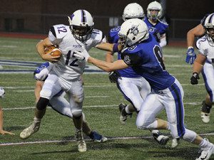 DS junior defensive back Luke Fielding (8) fights off a stiff arm from Norton’s Tyler Elliott (12) to make a tackle