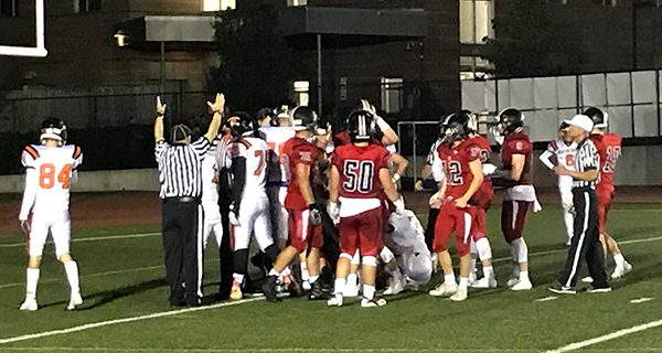 Referees signal a touchdown after Wellesley Quarterback Bert Greene sneaks the ball in from the goal line to make it 27-0 Wellesley in the third quarter. Photos by Robby McKittrick