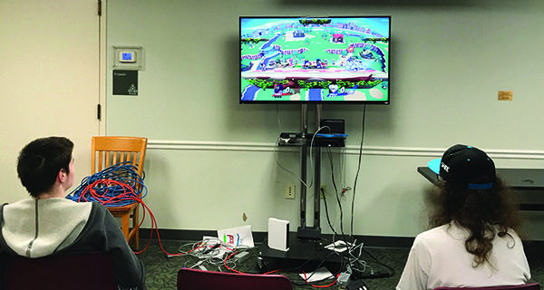 Two high school kids play against each other during a Super Smash Brothers tournament at the Medfield Library.