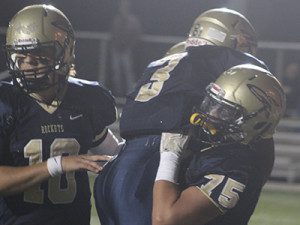 Charlie Ogletree (10) and Jake Doherty (75) mob Odahri Hibberts (3) in celebration following a second quarter touchdown.
