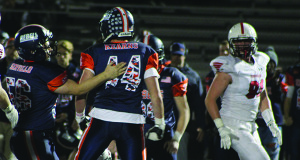 Pat Kearns (44) celebrates a tackle-for-loss with teammate Antonio Servello (56) late in the first quarter.