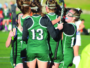 Hannah Blomquist (13), Elizabeth Watson (10), and teammates mob Abigail Crowley following her game-opening goal early in the first half.