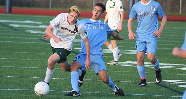 Kevin Lyons (16) and Nathan Parry (23) fight for positioning on a loose ball. Photos by Michael Flanagan