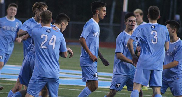 John McNeil (3) is congratulated by teammates Mike Vachon and Saul Lacerda following his go-ahead goal late in the first half. Photos by Michael Flanagan