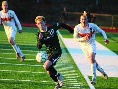 Westwood’s Mike TeDuits (10) tracks down a loose ball with Walpole’s Ryan Lewis (9) hot on his tail. Photos by Michael Flanagan