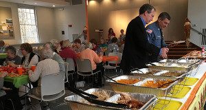 Selectman John Jeffries (left) and Sergeant Ed Meau (right) serve themselves lunch during the annual Thanksgiving luncheon at Dover Church.