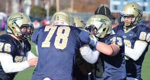Jacob Schneider (78), Timothy Hagerott (76), Matt Smith (80), and Will Baker (73) both Tyler Reid following his second quarter touchdown.