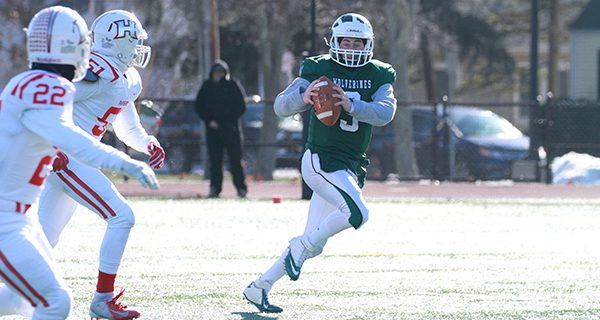Jake Pfaff (pictured) scrambles to his left and gets ready to heave the ball downfield. Photos by Mike Mao