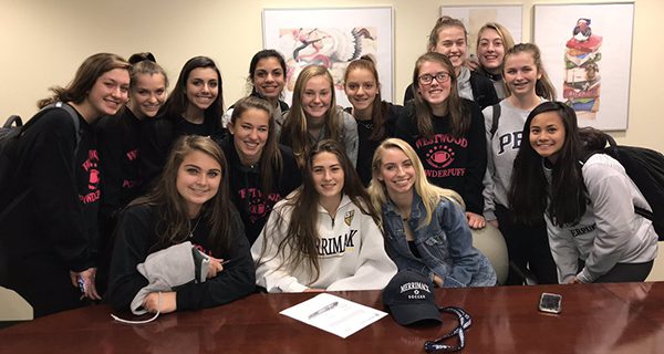 Pictured alongside her friends and teammates, Ali Reardon signs her NLI to play soccer at Merrimack; speaking volumes to just how close of a team Westwood girls soccer was in 2018. Photos by Westwood Athletics