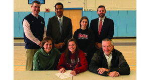 Erin Seibel (middle) is all smiles with her friends and family shortly after signing her NLI to attend UMass.