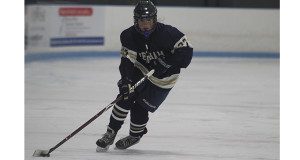 Junior right wing Charlotte Tolman (27) pears into the offensive zone and moves the puck up the ice for Needham during the Lady-Rockets 3-0 victory at Natick on Saturday night.