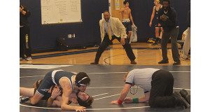The coaches become animated as their wrestler nears victory.